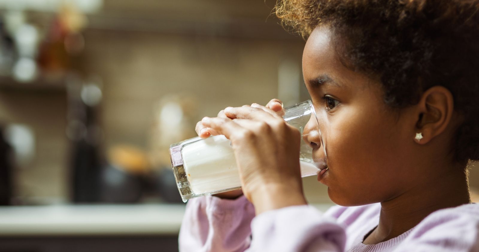 Young Girl Drinking Glass of Milk