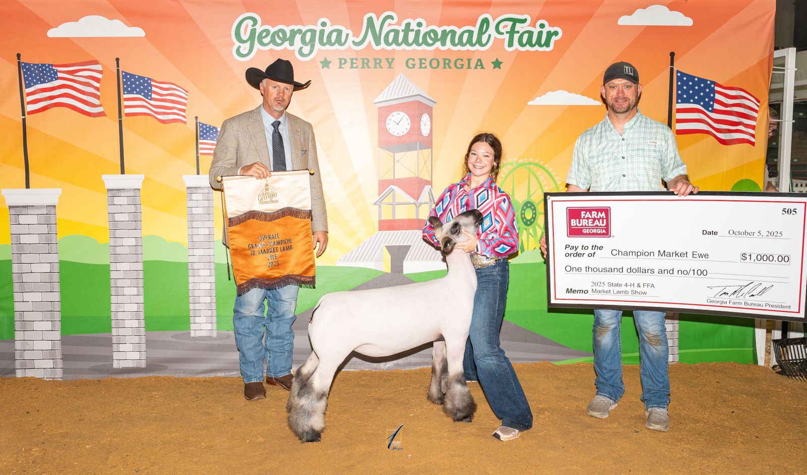 Teenage girl showing a lamb accepts prize banner from show judge and prize check from award sponsor.