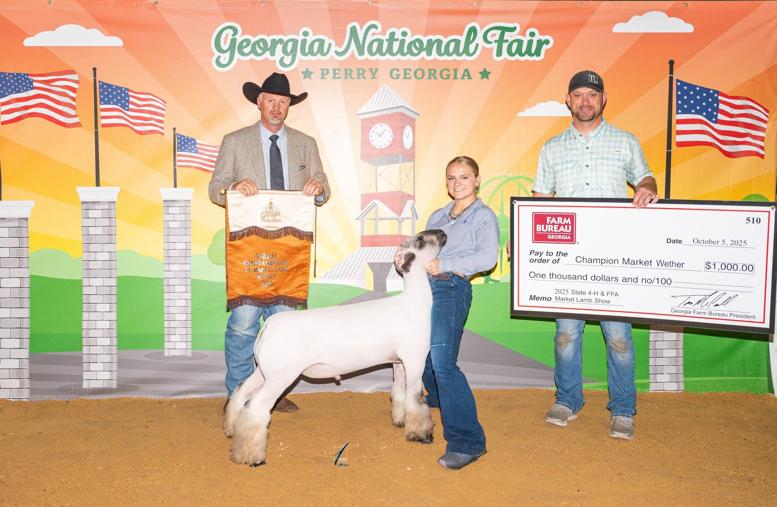 Teenage girl showing lamb accepts prize check from award sponsor and award banner from show judge.