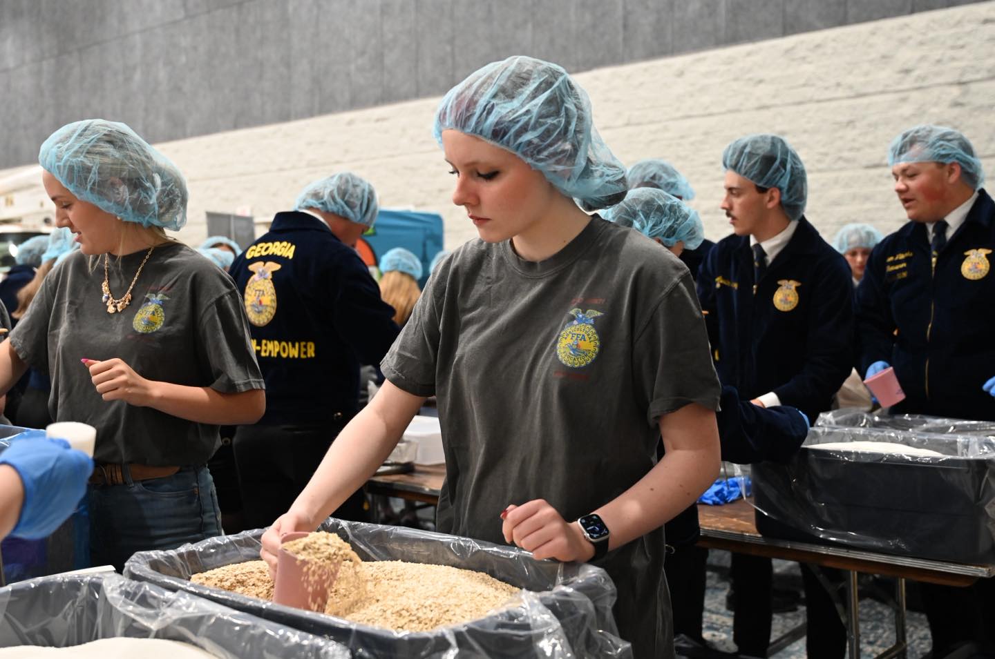 Students assemble pre-packaged meals.