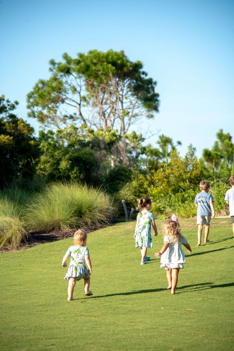Young Children running near marsh